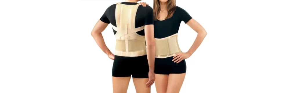 Man and woman standing next to each other with different Posture Correctors on. The man has a Vest-style corrector and the woman has a back brace. 